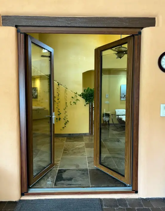 A door that is open and has two glass doors.