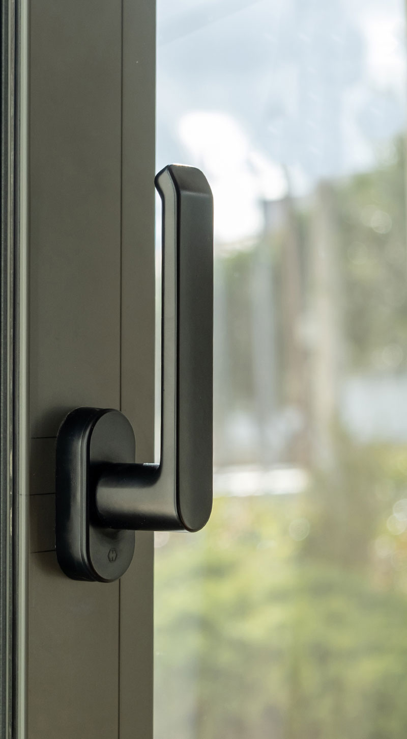 Black window handle on a modern energy-efficient window, showcasing European design and premium-grade hardware for residential use by VIP Smart Windows.