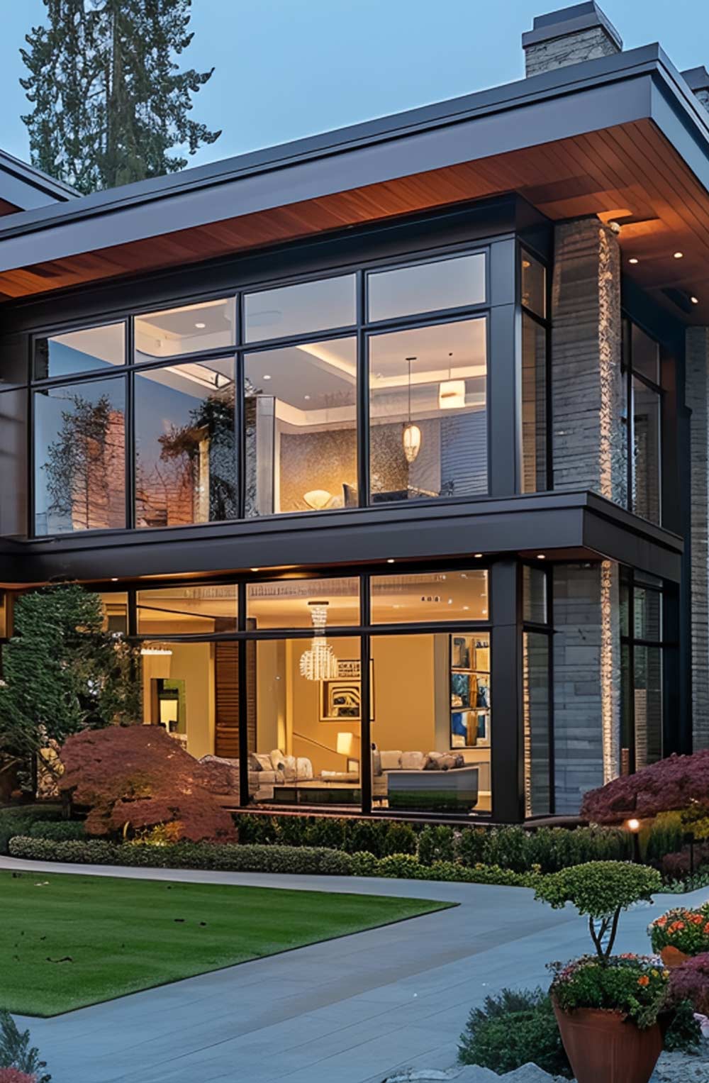 Modern house exterior featuring large, energy-efficient windows showcasing interior design elements, lush landscaping, and architectural details, emphasizing beauty and resilience in window installation by VIP Smart Windows.