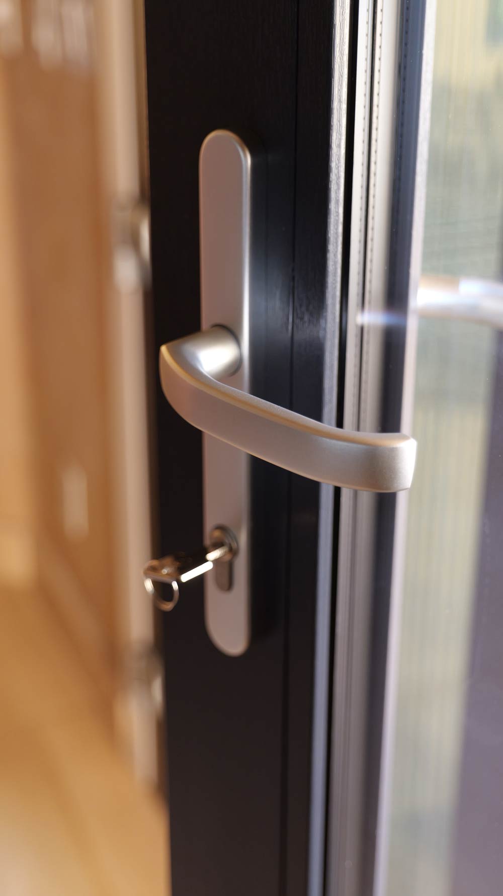 Modern door handle with keyhole, showcasing Italian hardware design for enhanced security and functionality, aligned with VIP Smart Windows' commitment to quality and innovation in window and door systems.